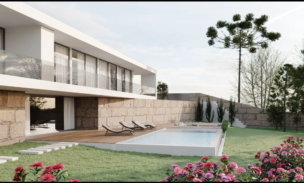 Jardim com relva tratada e canteiro desenhado pela Raízes Versáteis